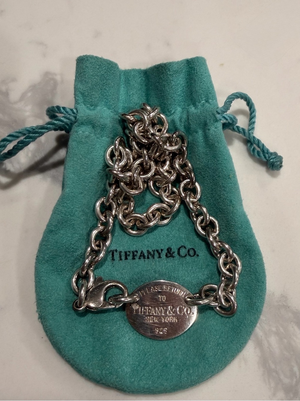 Tiffany & Co. Sterling Silver Oval Tag Bracelet on Robin’s Egg Blue Pouch